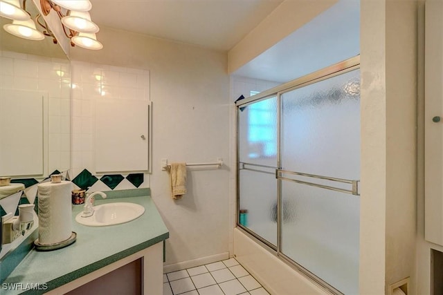 bathroom featuring vanity, bath / shower combo with glass door, tile patterned floors, and a chandelier