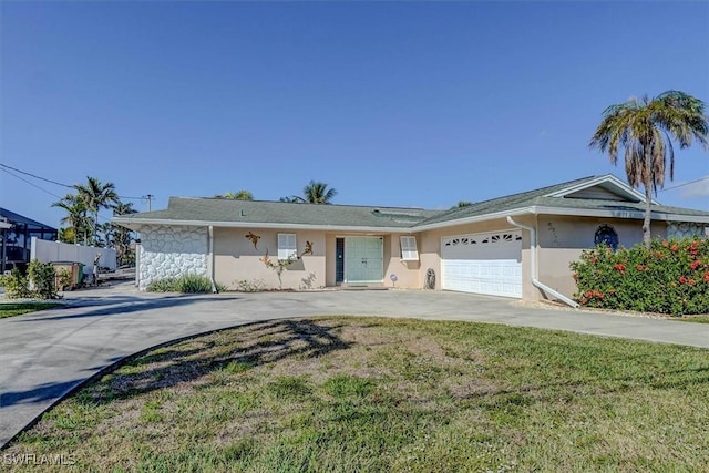 ranch-style house featuring a garage and a front yard