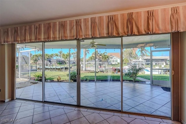 entryway with light tile patterned floors and ceiling fan