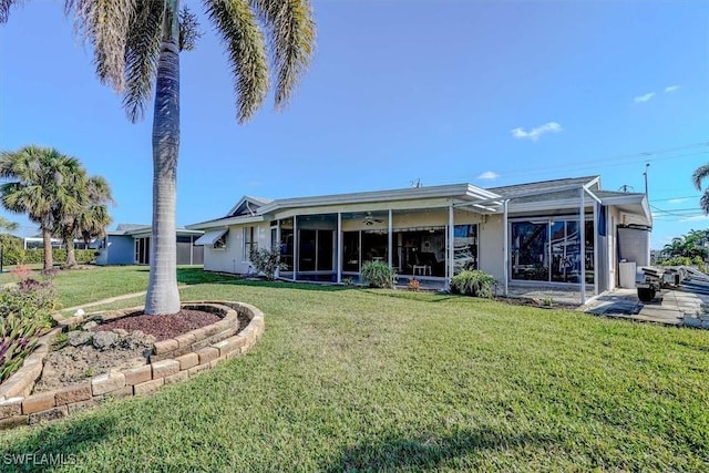 rear view of property with a yard