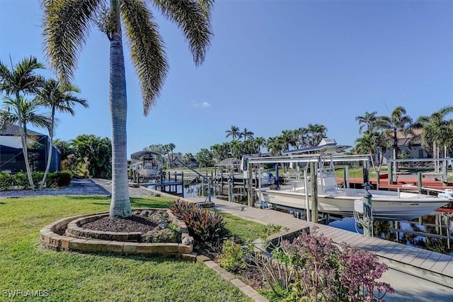 view of dock with a water view and a yard