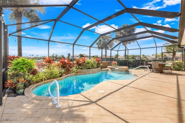 view of swimming pool featuring a patio, a pool with connected hot tub, and a lanai