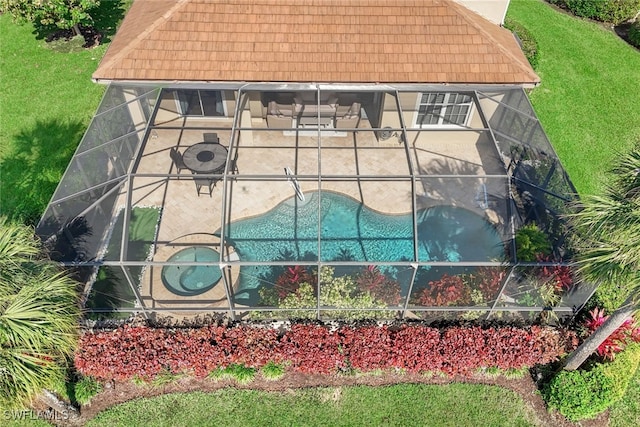exterior space with an outdoor pool and a lawn