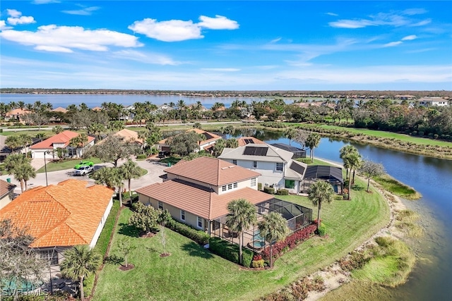 drone / aerial view with a residential view and a water view