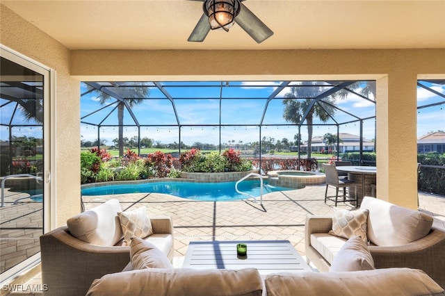view of swimming pool with a patio area, a pool with connected hot tub, a ceiling fan, an outdoor living space, and glass enclosure