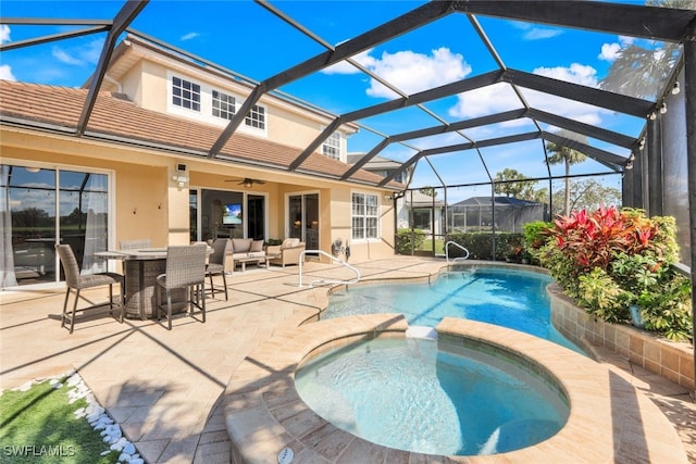 view of pool with a patio, an outdoor living space, a ceiling fan, a pool with connected hot tub, and glass enclosure