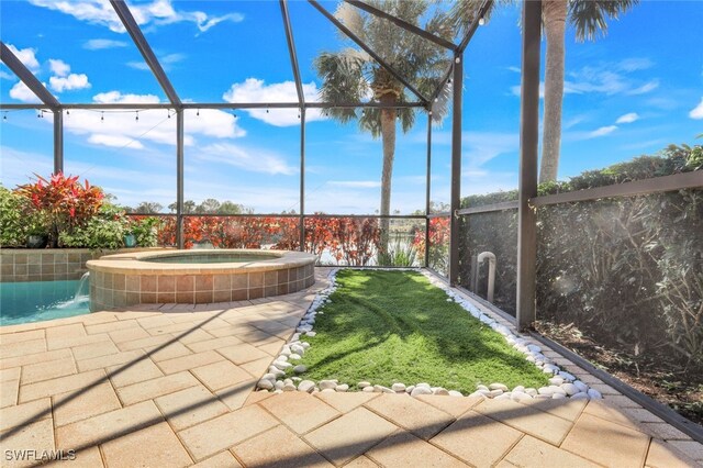 view of yard with a patio area, an in ground hot tub, and glass enclosure