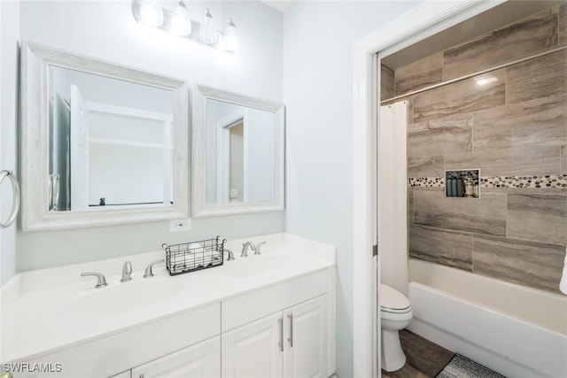full bath with shower / tub combo with curtain, double vanity, a sink, and toilet