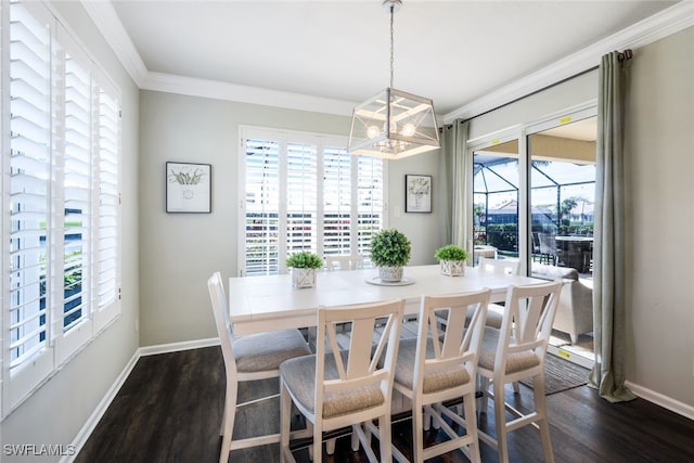 dining area with dark wood finished floors, a notable chandelier, baseboards, and ornamental molding