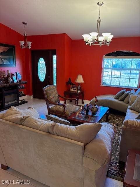 living room with light tile patterned flooring and an inviting chandelier