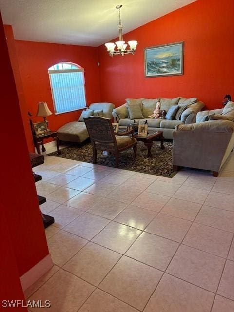 living room featuring vaulted ceiling, light tile patterned floors, and a notable chandelier