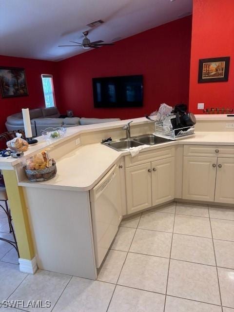 kitchen with light tile patterned flooring, dishwasher, sink, and kitchen peninsula