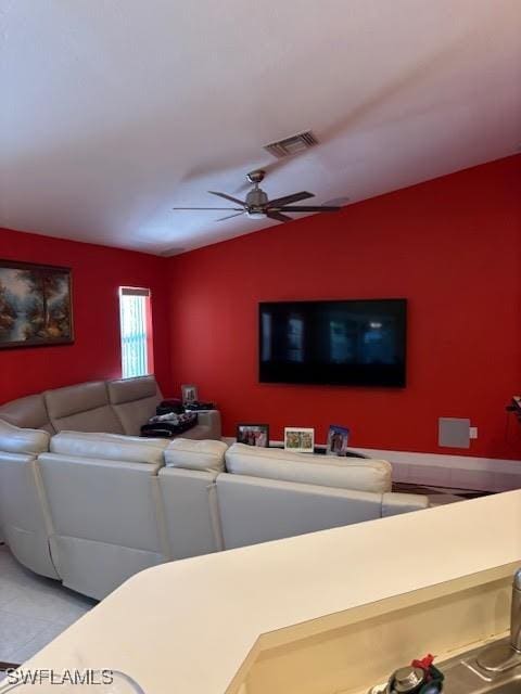 living room with ceiling fan and vaulted ceiling