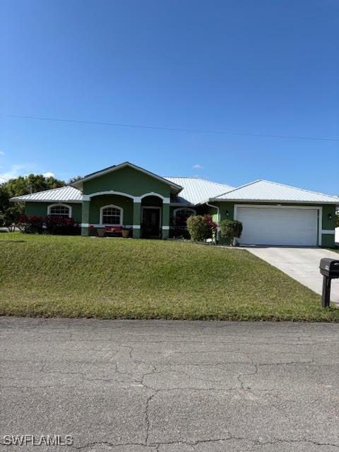 ranch-style home with a garage and a front yard