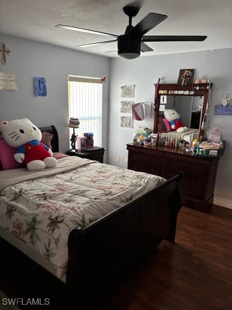 bedroom with ceiling fan and dark hardwood / wood-style flooring