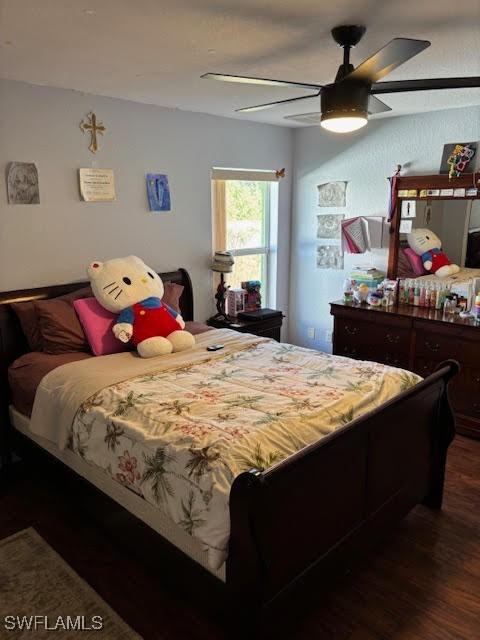 bedroom featuring ceiling fan and dark hardwood / wood-style floors