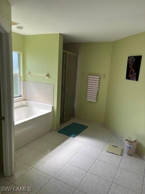 bathroom featuring independent shower and bath and tile patterned floors