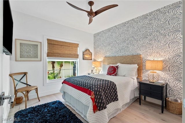 bedroom with ceiling fan and light hardwood / wood-style flooring