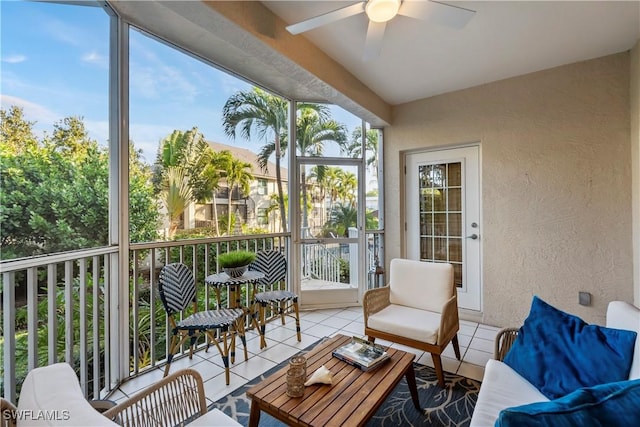 sunroom / solarium featuring ceiling fan