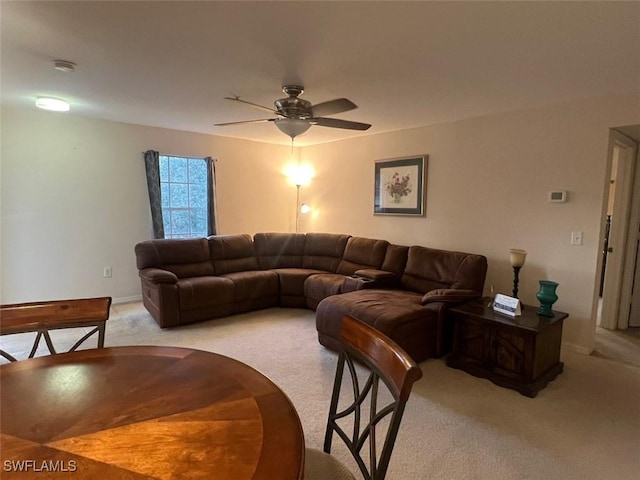 living area featuring a ceiling fan and light carpet