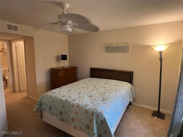 bedroom featuring baseboards, visible vents, ceiling fan, and light colored carpet