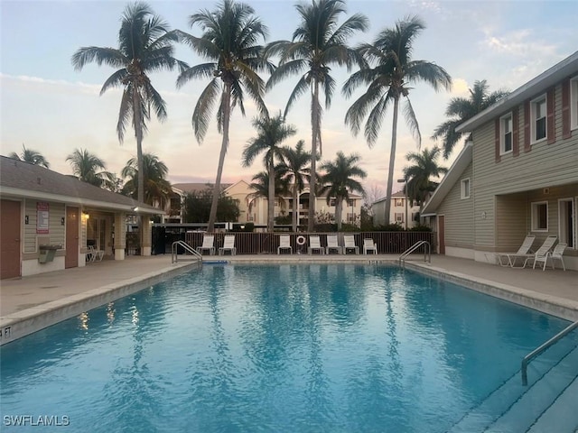 community pool featuring fence and a patio