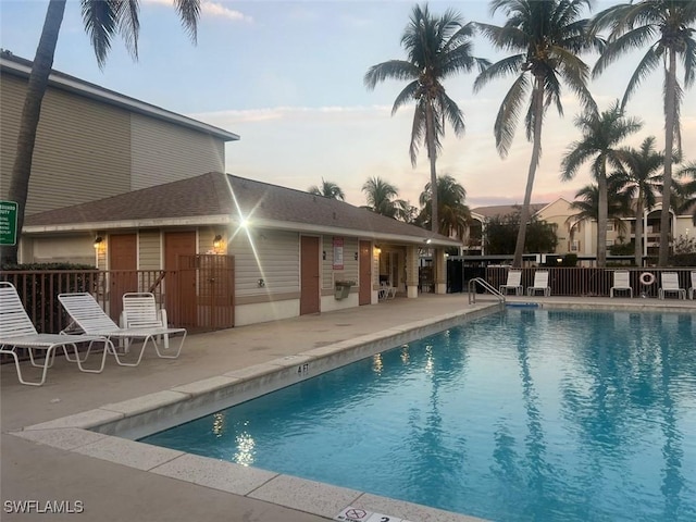 pool with fence and a patio