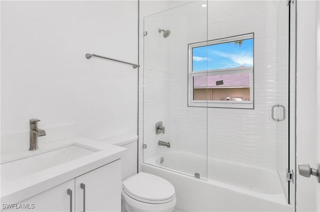 full bathroom with vanity, combined bath / shower with glass door, and toilet