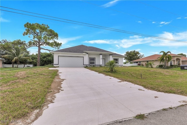 view of front of property with a garage and a front lawn