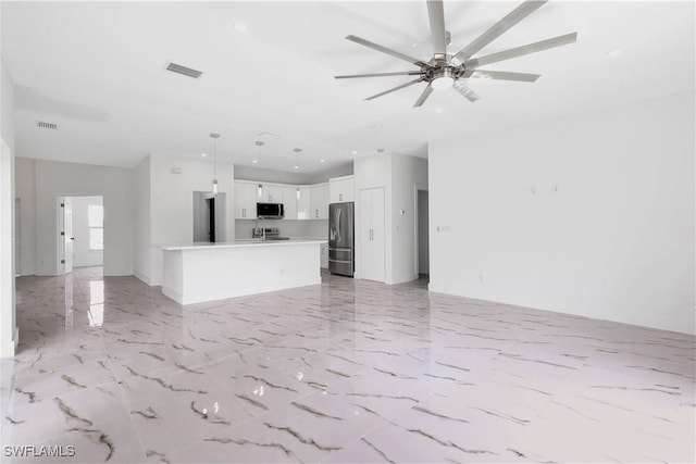 unfurnished living room with ceiling fan