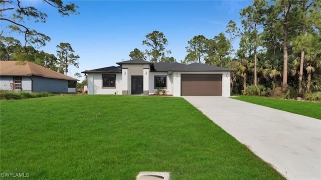 view of front of house with a garage and a front lawn