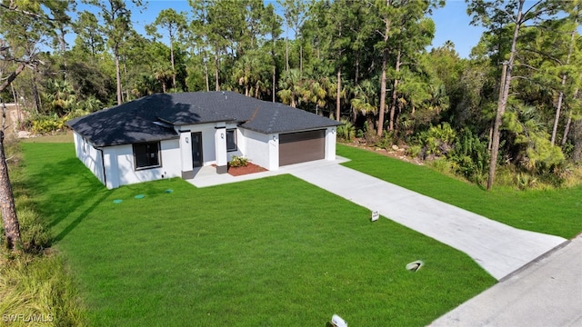 view of front of house with a garage and a front lawn