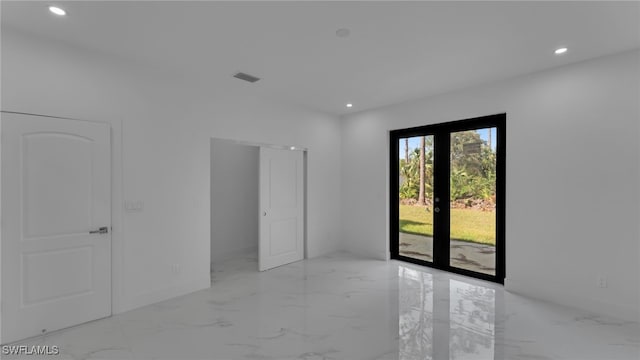 spare room featuring french doors