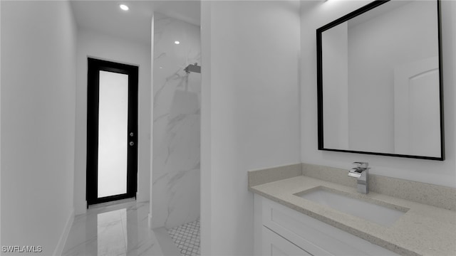 bathroom featuring vanity and a shower