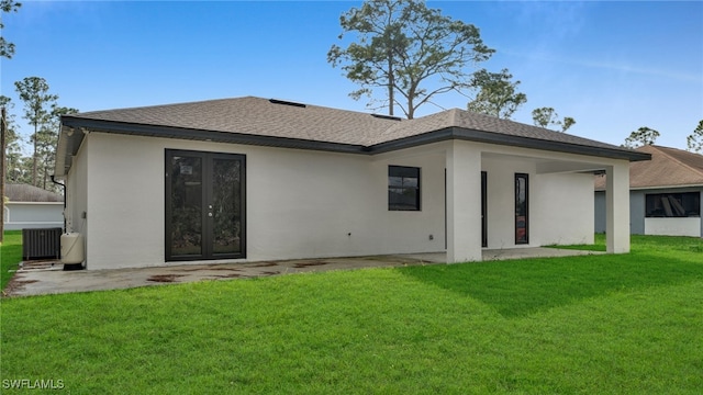 back of house featuring central AC unit, a yard, and a patio