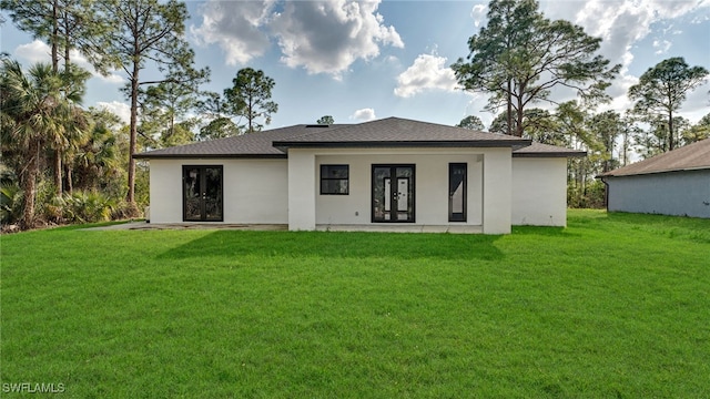 back of house with a yard and french doors