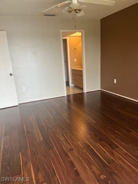 unfurnished room with visible vents, baseboards, a ceiling fan, and wood finished floors