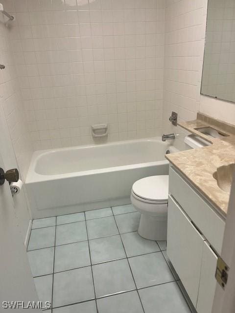 bathroom with tile patterned flooring, vanity, toilet, and shower / bathing tub combination