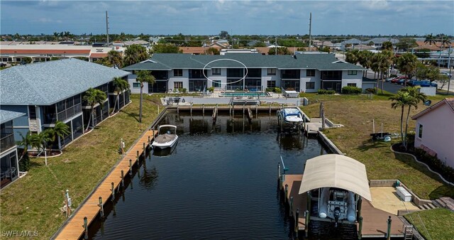 808 Cape Coral Pkwy W Unit 204, Cape Coral, FL 33914 - drone / aerial view featuring a water view and a residential view