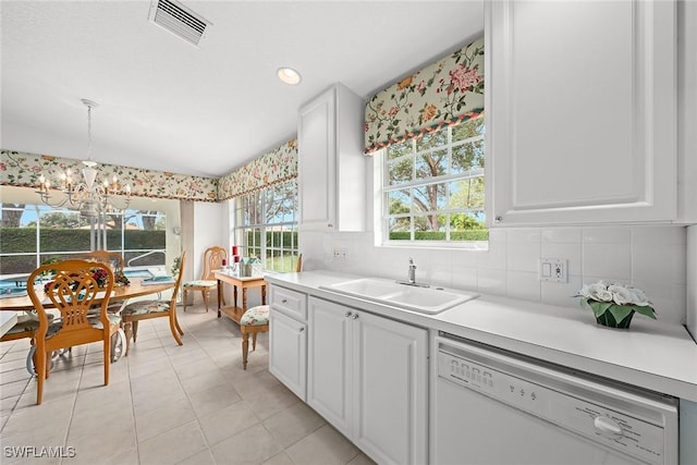 kitchen with visible vents, dishwasher, light countertops, white cabinetry, and a sink