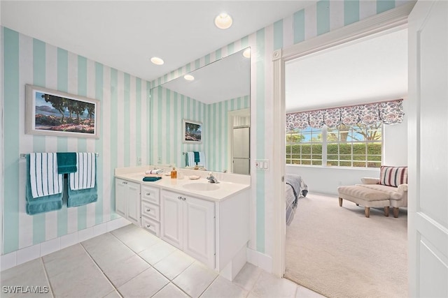 full bath featuring double vanity, wallpapered walls, ensuite bath, a sink, and recessed lighting