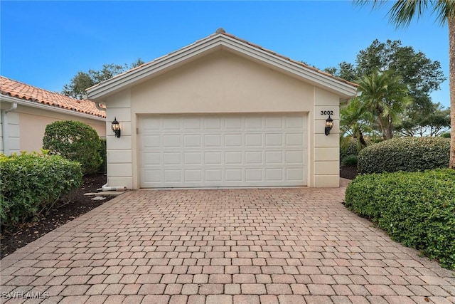 garage featuring decorative driveway