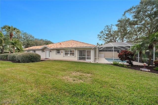 back of house featuring a tile roof, stucco siding, a lawn, glass enclosure, and an outdoor pool