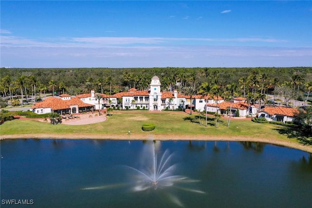 birds eye view of property with a water view and a view of trees