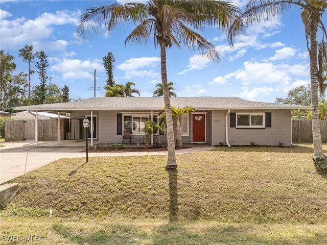 ranch-style house featuring a carport and a front yard