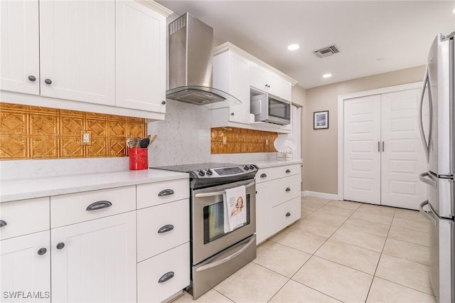 kitchen with extractor fan, tasteful backsplash, light tile patterned floors, appliances with stainless steel finishes, and white cabinets