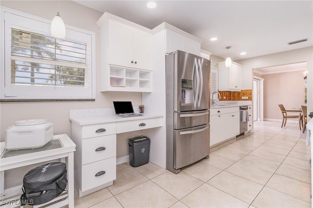 kitchen featuring white cabinetry, appliances with stainless steel finishes, light tile patterned flooring, and pendant lighting