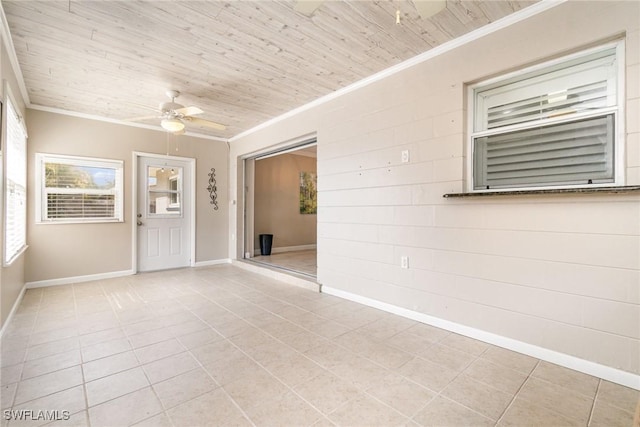 empty room featuring crown molding, ceiling fan, wood ceiling, and light tile patterned floors