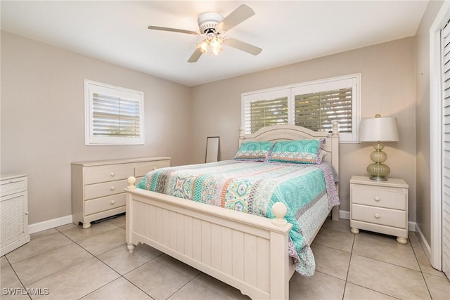 tiled bedroom featuring ceiling fan