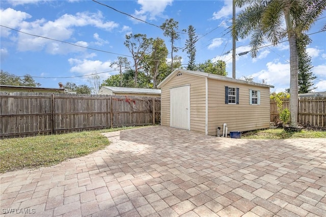 view of patio / terrace featuring a storage shed